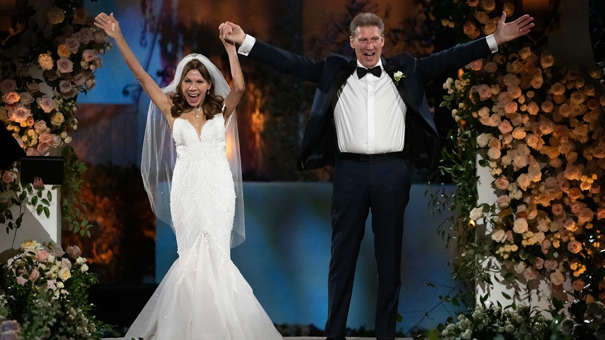 Theresa Nist and Gerry Turner of the 'Golden Bachelor' hold hands in the air after getting married